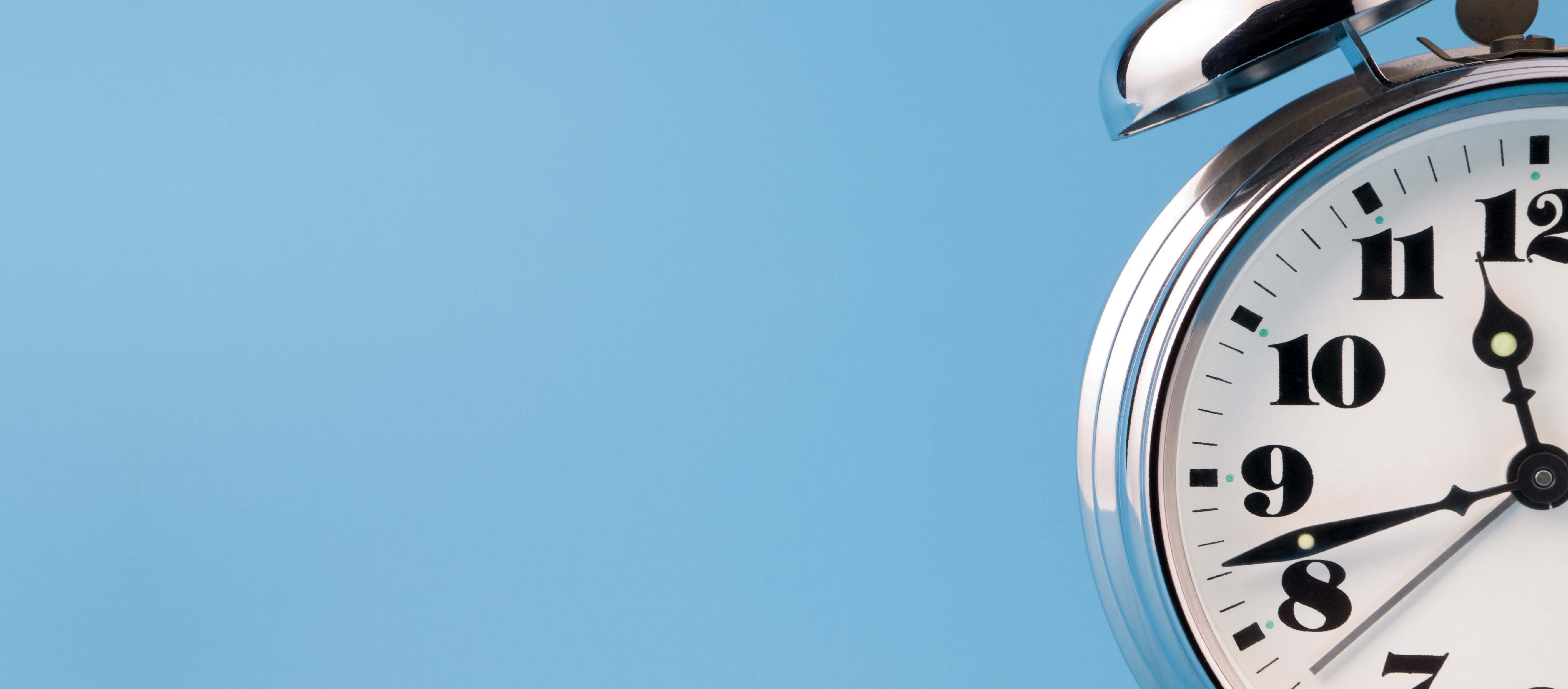 Analog alarm clock showing 11:42